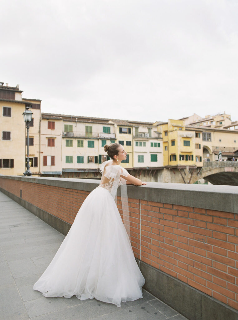 A girl standing by Ponte Vecchio