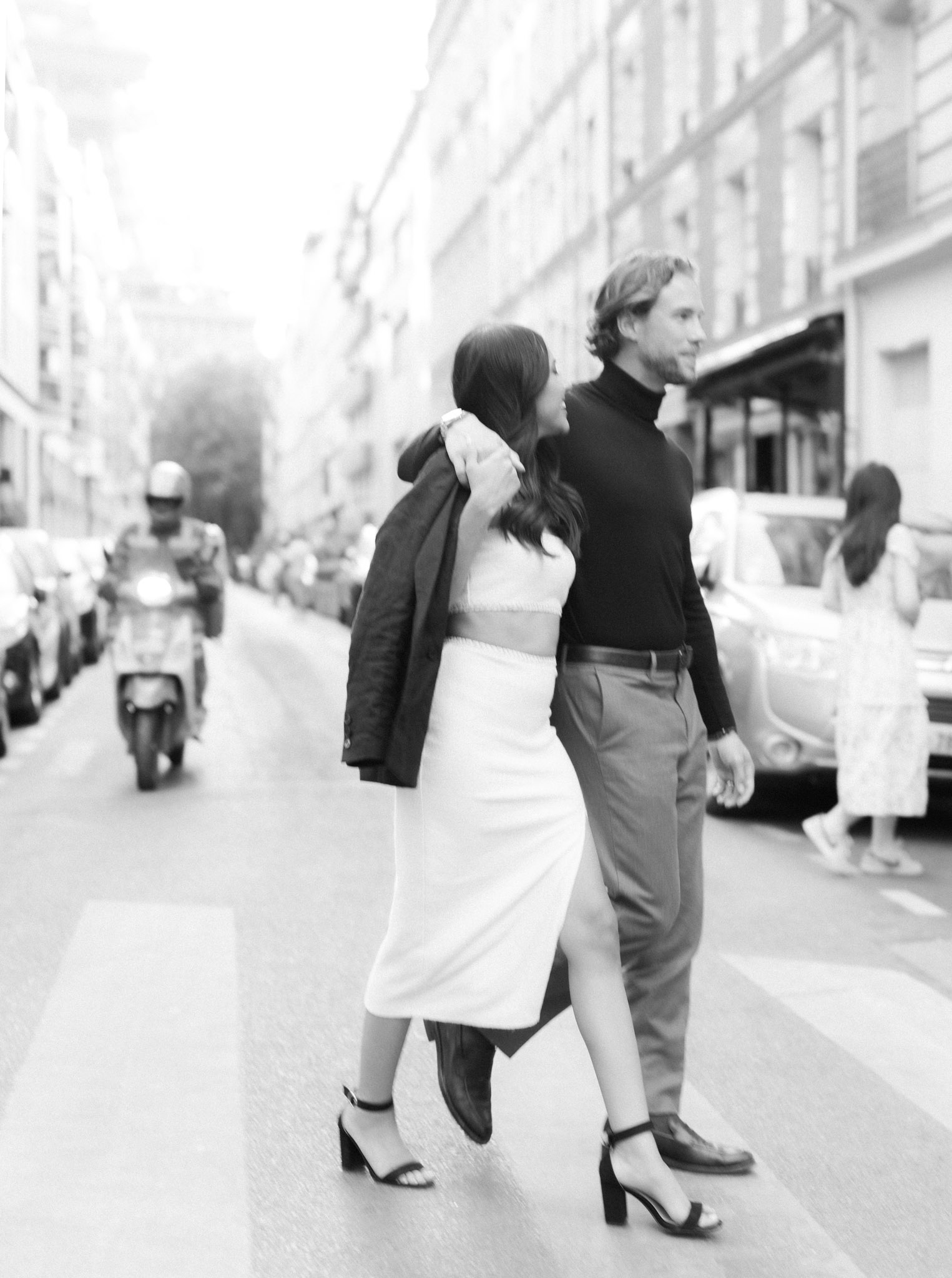 A newly engaged couple walking on street of Paris 