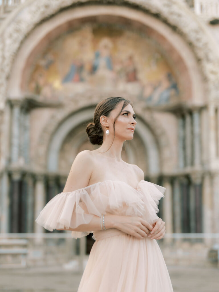 A woman standing in front of Saint Mark's Basilica