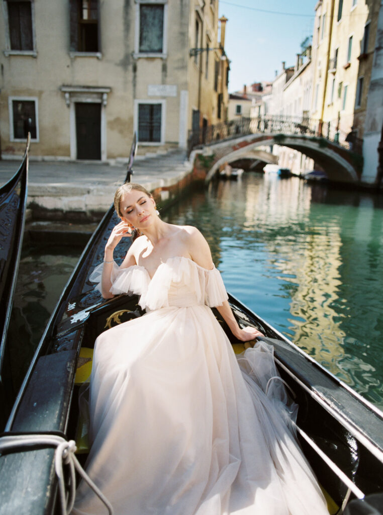 A woman sitting in a gondola in Venice