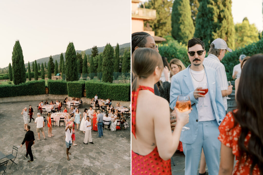 A side-by-side diptych of an outdoor wedding reception at a Tuscan estate. On the left, an elevated wide shot shows guests mingling and seated at round tables on a stone terrace, framed by a tall manicured hedge and a row of cypress trees with rolling hills beyond. On the right, a closer shot captures guests socializing at golden hour.